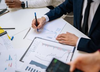 Professionals analyzing financial charts in a corporate setting. — Avoid Delays by Understanding Squatters Rights 30 Days Ind