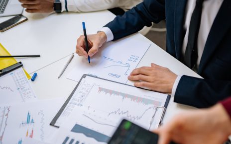 Professionals analyzing financial charts in a corporate setting. — Avoid Delays by Understanding Squatters Rights 30 Days Ind