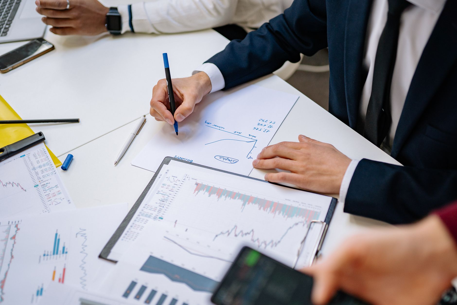 Professionals analyzing financial charts in a corporate setting. — Avoid Delays by Understanding Squatters Rights 30 Days Ind